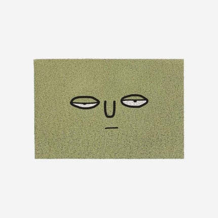 Felpudo verde divertido con cara