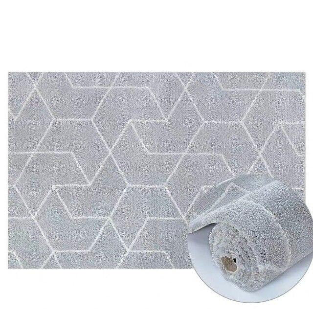 Alfombra shaggy gris con motivos geométricos.