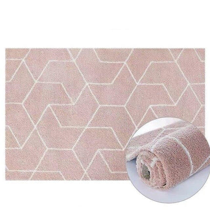 Alfombra geométrica shaggy de color rosa empolvado.