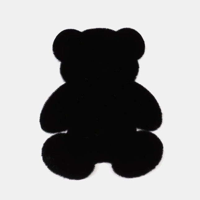Alfombra de dormitorio negra forma de oso.